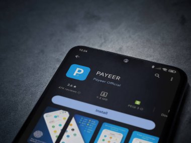 Lod, Israel - 16 Temmuz 2023: PaYEER uygulama oyun mağazası sayfası kara mermer taşlı arka planda. Üst görünüm düzlüğü kopyalama alanı ile yatıyordu.