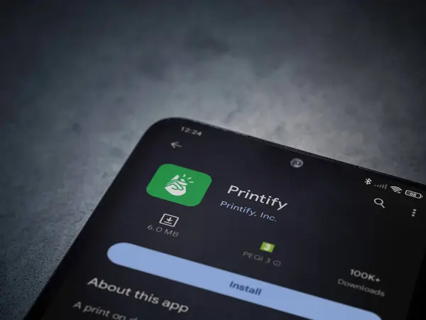 stock image Lod, Israel - July 16,2023: Printify app play store page on smartphone on a dark marble stone background. Top view flat lay with copy space.