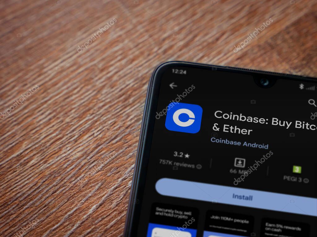 Lod, Israel - July 16,2023: Coinbase app play store page on smartphone on wooden background. Top view flat lay with copy space.