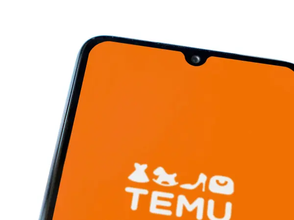 Stock image Lod, Israel - July 16,2023: Temu app launch screen on smartphone on white background. Top view flat lay with copy space.