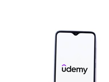 Lod, Israel - 16 Temmuz 2023: Udemy uygulaması beyaz arka planda akıllı telefondan çalıştırma ekranı. Üst görünüm düzlüğü kopyalama alanı ile yatıyordu.