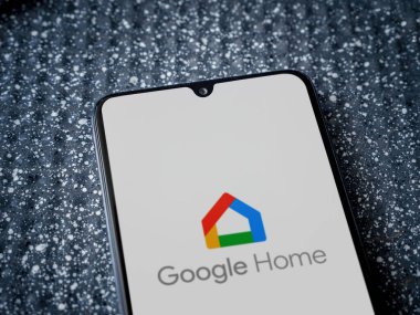 Lod, Israel - 16 Temmuz 2023: Google Home uygulama ekranı metalik arka planda akıllı telefon. Üst görünüm yatağını kapat.