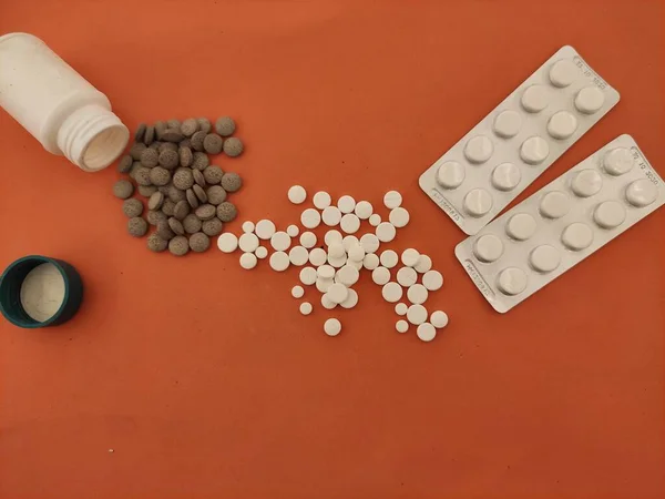 medicine, pills on an orange background