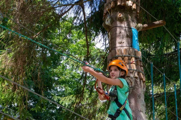 stock image adventure climbing high wire park - people on course in mountain helmet and safety equipment. High quality photo