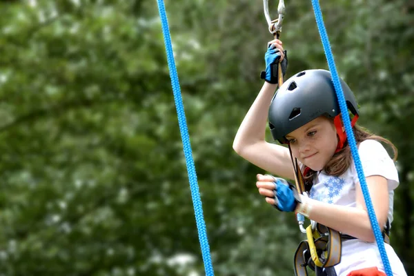 stock image adventure climbing high wire park - people on course in mountain helmet and safety equipment. High quality photo