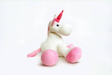 Lovely white pony doll isolated on white background. Adorable teddy bear for decorative. High quality photo