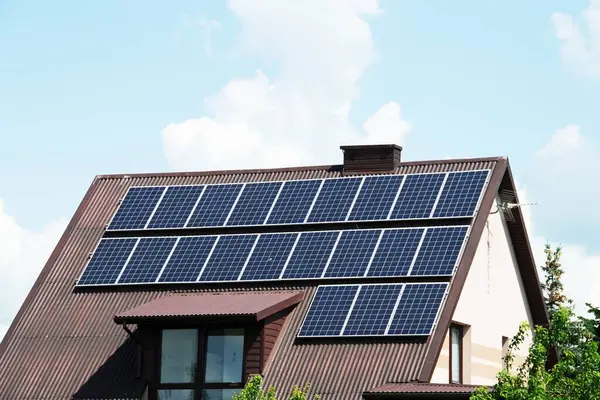 stock image Installing a Solar Cell on a Roof. Solar panels on roof. Historic farm house with modern solar panels on roof and wall. High quality photo