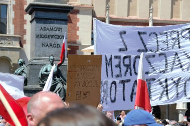 Krakow, Poland - June 4 2023: Protesters shold banners with critical and satirical slogans and pictures against Polish government while join demonstration to support democracy. High quality photo clipart