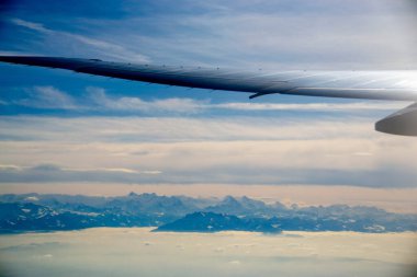 White passenger airplane flying in the sky amazing clouds in the background - Travel by air transport. High quality photo clipart