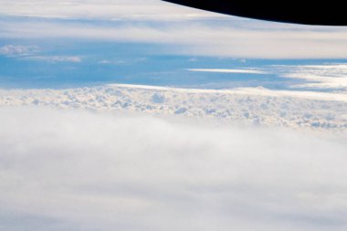 White passenger airplane flying in the sky amazing clouds in the background - Travel by air transport. High quality photo clipart