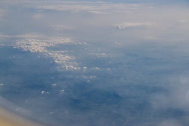 White passenger airplane flying in the sky amazing clouds in the background - Travel by air transport. High quality photo clipart