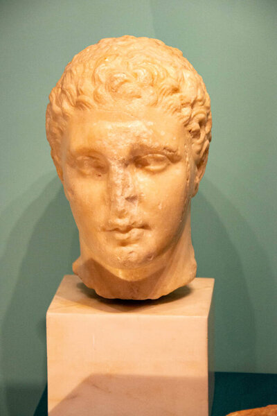 cartoonishly large bossom on marble godess sculpture. Museum photography. Ancient roman marble statue.Young person figure statue isolated on colored background. Antique sculpture. High quality photo