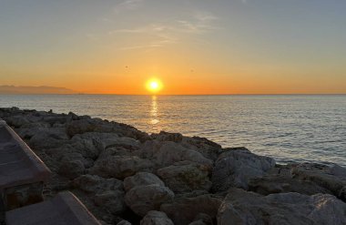 Sunset over the Mediterranean sea, seen from the coast in Torremolinos, Andalusia, Spain.