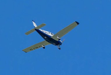 Pervaneli uçak Piper PA-28-161 Güney İsveç üzerinde mavi gökyüzü karşı.