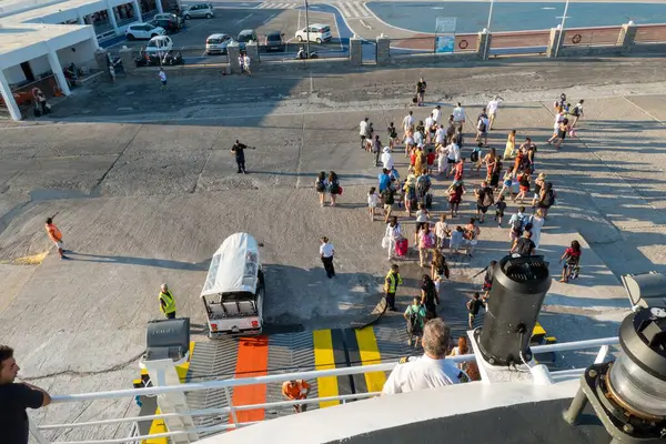 stock image Travelers at the harbor in the island Tinos, Greece.