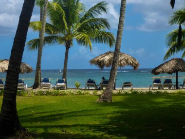 Beach with sunbeds at Hotel Grand Bahia Principe in the Northern part of Dominican Republic, Caribbean. clipart