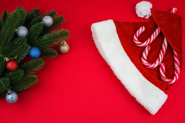 stock image Christmas composition. Christmas red decorations, fir tree branches on red background. Flat lay.