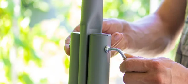 stock image man collects garden furniture, close-up. Selective focus