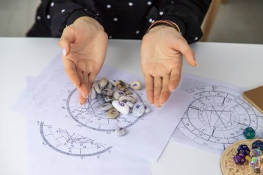 Woman numerologist astrologer counts numbers. Selective focus. People.