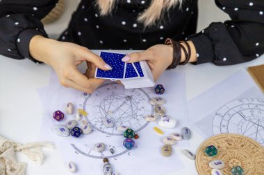 Woman astrologer draws a natal chart. Selective focus. People.