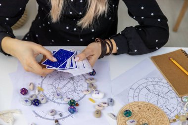 Woman astrologer draws a natal chart. Selective focus. People.