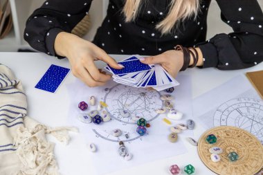 Woman astrologer draws a natal chart. Selective focus. People.