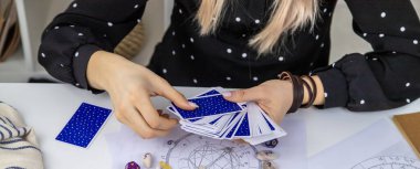 Woman astrologer draws a natal chart. Selective focus. People.