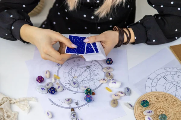 Woman astrologer draws a natal chart. Selective focus. People.