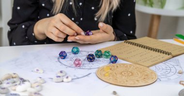 Woman numerologist astrologer counts numbers. Selective focus. People.