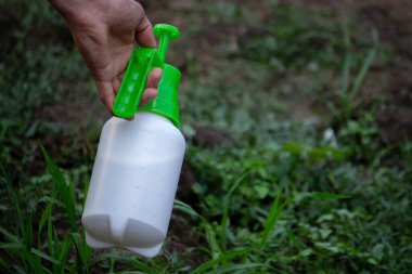farmer sprays weeds in the garden. Selective focus. nature