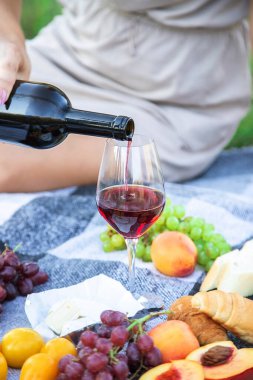 picnic in nature, girl pouring wine, couple in love. nature. selective focus