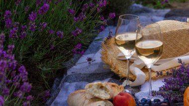 wine, fruits, berries, cheese, glasses picnic in lavender field Selective focus Nature