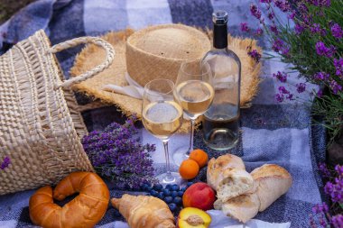 wine, fruits, berries, cheese, glasses picnic in lavender field Selective focus Nature