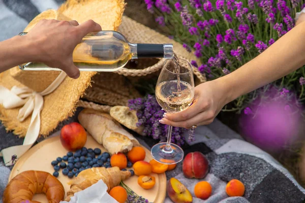 stock image wine, fruits, berries, cheese, glasses picnic in lavender field Selective focus Nature