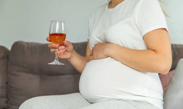 Stock image A pregnant woman drinks wine in a glass. Selective focus. Food.