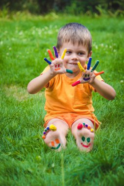 a smile painted with paints on the child's arms and legs. Selective focus