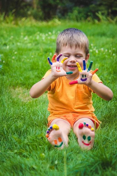 a smile painted with paints on the child\'s arms and legs. Selective focus
