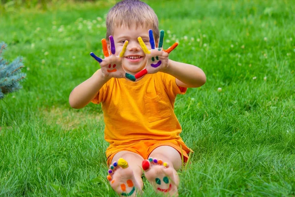 a smile painted with paints on the child\'s arms and legs. Selective focus