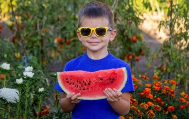A child eats a watermelon. Selective focus. Nature