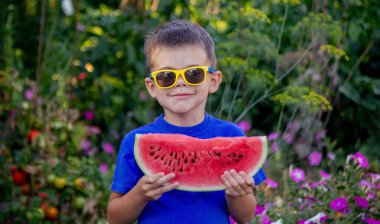 A child eats a watermelon. Selective focus. Nature