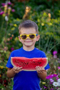 A child eats a watermelon. Selective focus. Nature