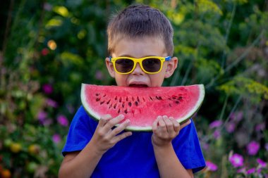 A child eats a watermelon. Selective focus. Nature