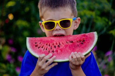 A child eats a watermelon. Selective focus. Nature