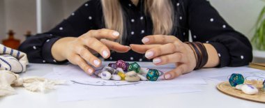 Woman numerologist astrologer counts numbers. Selective focus. People.