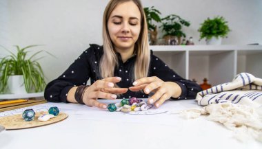 Woman numerologist astrologer counts numbers. Selective focus. People.