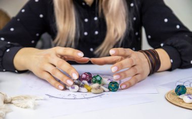 Woman numerologist astrologer counts numbers. Selective focus. People.