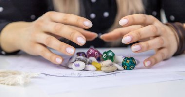 Woman numerologist astrologer counts numbers. Selective focus. People.