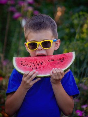 A child eats a watermelon. Selective focus. Nature