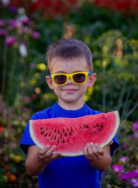 A child eats a watermelon. Selective focus. Nature