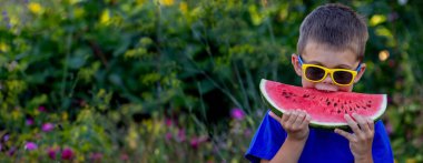 A child eats a watermelon. Selective focus. Nature